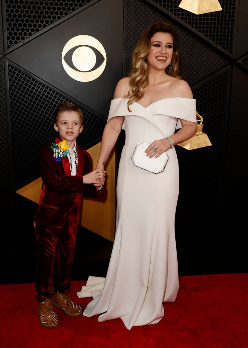 Remington Alexander and Kelly Clarkson on the red carpet at the 66th Grammy Awards.