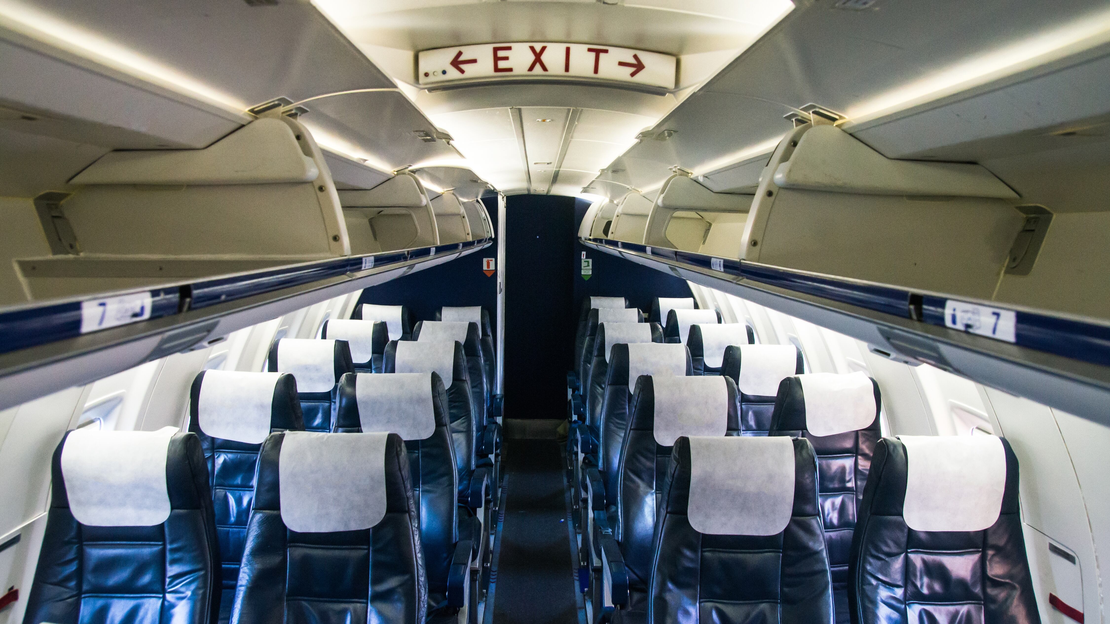 Open luggage rack and interior view of the small regional passenger airplane